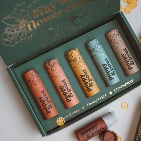 Let’s play the greatest hits! These five are famous for a reason: they’re Poppy & Pout classics. Grab our tried and true go-tos that have been selling out since day one. Includes Sweet Mint, Island Coconut, Pomegranate Peach, Wild Honey, and Orange Blossom. Get in touch with your inner flower child with our vintage inspired, 100% natural lip balms. Each balm is hand poured into beautifully designed, 100% recyclable cardboard tubes. Net Weight per Tube: .3oz / 8.5g Lip Balm Packaging, Mint Lip Balm, Peach Lip Balm, Honey Lip Balm, Coconut Lip Balm, Peach Lips, Sweet Mint, Cosmetic Packaging Design, Makeup Package