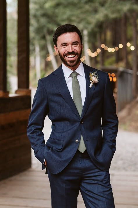 Groom in dark blue suit with olive tie. Mountain wedding elopement at Blackstone Rivers Ranch, Colorado. Captured by Larsen Photo Co, Colorado Elopement Photographer. Grooms Suit Ideas Wedding, Navy Suit And Green Tie, Navy Blue Suit With Olive Green Tie, Navy Wedding Groom, Navy Blue Groom And Groomsmen Suits, Navy Blue Suit Green Tie Wedding, Blue Tux With Green Tie, Blue Suit Sage Tie, Dark Blue Suit Green Tie