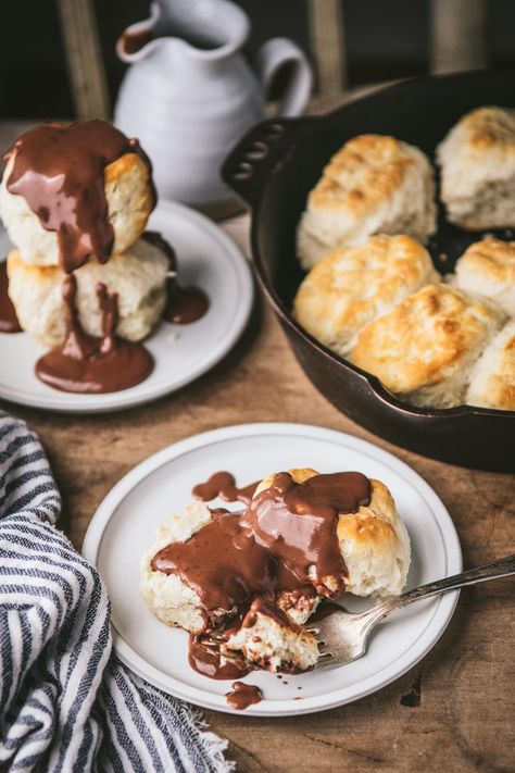 Chocolate gravy is a classic Southern treat! Served over warm buttermilk biscuits for breakfast, or drizzled on pound cake and ice cream for dessert, this easy recipe has been delighting both kids and adults for generations. Best of all, it only requires a handful of basic ingredients that you probably already have in your kitchen -- and it's ready in about 15 minutes! Chocolate And Biscuits Recipe, Biscuits And Chocolate Gravy, Buttermilk Bisquits, Chocolate Gravy Recipe, Biscuits For Breakfast, Southern Buttermilk Biscuits, Chocolate Gravy, Cake And Ice Cream, 2023 Recipes