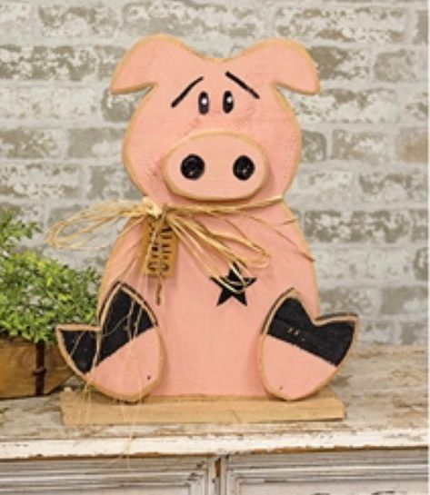 "It's easy to pig-out on farmhouse decor with the Rustic Oink Pig. This adorable figurine is in the shape of a plump pig sitting down and constructed of chunky wood with a raw, unfinished texture. The pig has a bright pink finish and a layered design. He has an expressive painted face and a charming raffia bow with a paper tag that reads \"oink\". The pig sits atop a wooden base for a sturdy, freestanding display. Great for a porch, mud room or entryway in the home. Measures 18.75\" high by 15\" wide by 3.5\" deep. Made in the USA!" Pig Decorations, Diy Pig Decor, Painted Pigs On Wood, Wooden Pig Decor, Pig Wood Carving, Wood Pig, Scrap Wood Art, Pig Crafts, Barn Wood Crafts