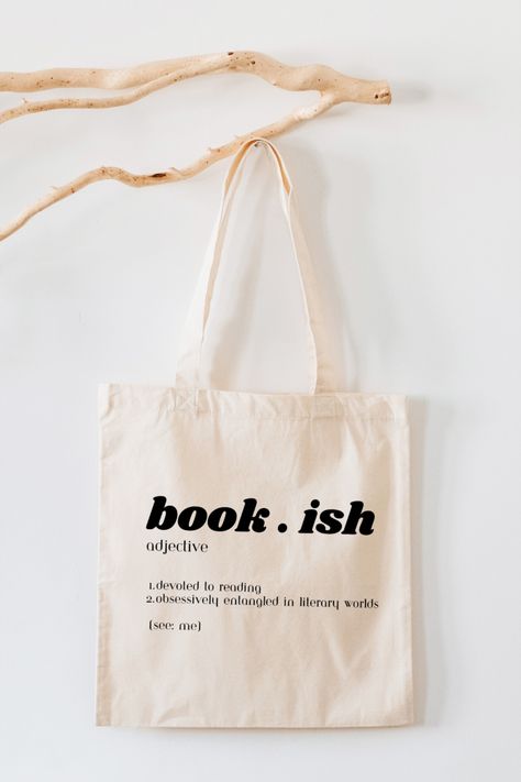 A cotton tote bag featuring the word 'bookish' along with its definition. The bag is stylishly designed, with the word and definition prominently displayed. It's a perfect accessory for book lovers and literary enthusiasts, showcasing their passion for books and reading. Design Totebag Aesthetic, Bookish Tote Bag, Product Flatlay, Books Tote Bag, Tote Bag Business, Book Shops, Minimalist Tote Bag, Tote Bags For School, Funny Items