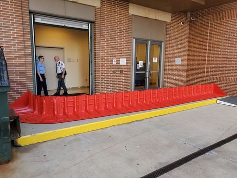 Mayim™ Flood Barriers Connected to Create Continuous flood protection barrier, blocking industrial garage door and entryway Flood Mitigation, Garage Entryway, Flood Barrier, Flood Protection, Updating House, Home Repairs, Cool Inventions, Extreme Weather, Work Office