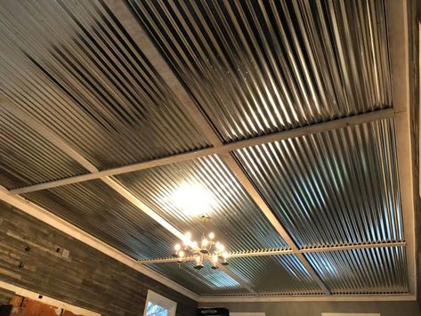 Galvanized, corrugated metal with whitewashed rough sawn cottonwood trim in a grid pattern. Corrugated Metal Ceiling Basement, Corrugated Tin Ceiling Kitchen, Coragated Metal Ceiling Ideas, Galvanized Ceiling Ideas, Corrugated Metal House, Galvanized Tin Ceiling, Galvanized Metal Ceiling, Metal Ceiling Ideas, Corrugated Ceiling