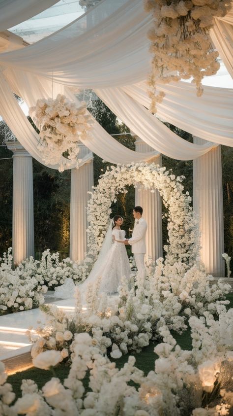 Step into a dreamlike garden wedding with this Ethereal White Wedding setup! 🌿✨ Surrounded by floating floral arches, soft drapery, and glowing candlelight, this wedding theme captures the essence of romantic, enchanted elegance. Perfect for couples who want a fairytale-inspired ceremony filled with delicate white blooms and magical ambiance.

📌 Save this pin for your wedding inspiration and visit SweetPeasAndTeas.com for more breathtaking all-white wedding themes! #EtherealWedding #WhiteWedding #WeddingInspiration #FairytaleBride #GardenRomance White Decor Wedding, Ethereal Wedding Theme, White Wedding Aesthetic, Weddings Decorations Elegant Romantic, Ethereal Garden, Fairytale Romance, Wedding Setup, Floral Arches, Vintage Hollywood Glamour