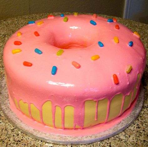 cute donut cake | Super fun to make!! 14" round, 5" tall cake. Cake is covered with ... Pink Donut Cake, Donut Cake Birthday, Simpsons Donut, Donut Birthday Cake, Kawaii Party, Donut Themed Birthday Party, Tall Cake, Donut Cake, Pink Donut