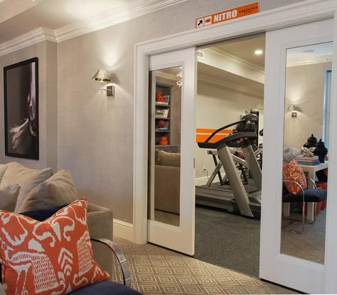 Mirrored pocket doors open to a basement workout room filled with exercise equipment. Workout Room Design, Basement Workout Room, Basement Home Gym, Basement Gym Ideas, Workout Room Home, Piscina Interior, Basement Gym, Basement Inspiration, Workout Room