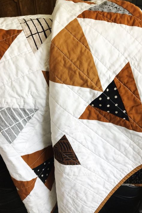 Great quilt for the Fall modern minimalist nursery. It's made with rich shades of brown mixed with linen fabrics in complementary colors giving it great texture.  It's perfect for a baby boy into his toddler years as a crib quilt, for tummy time, and snuggling on the couch. Would also be a striking wall hanging, lap quilt or over the back of a chair. Pattern is Mod Mountains by Suzy Quilts. #minimalistnursey #babyshowergift #modmountainsquilt #babyquiltforsale #Fallquilt #lapquilt #wallhanging Mod Mountains Quilt, Earth Tone Quilt, Boho Quilt Pattern, Modern Boy Quilt, Modern Minimalist Nursery, Triangle Mountain, Brown Quilts, Boho Baby Quilt, Modern Baby Quilts