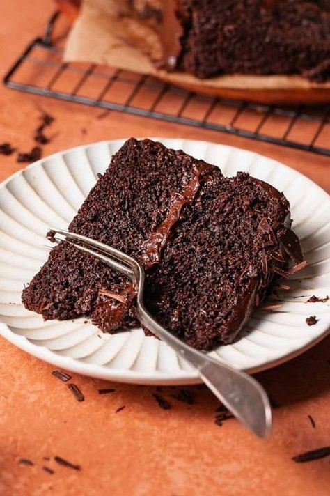 There's so much to love about this super moist chocolate cake! With a rich chocolate flavor and soft texture, it's smothered in glossy chocolate frosting and topped with chocolate shavings. Think Matilda's cake- but even better! | Cambrea Bakes Cambrea Bakes, Best Moist Chocolate Cake, Super Moist Chocolate Cake, Chocolate Frosting Recipes, Fudge Frosting, Homemade Cake Recipes, Moist Chocolate Cake, Chocolate Shavings, Chocolate Frosting