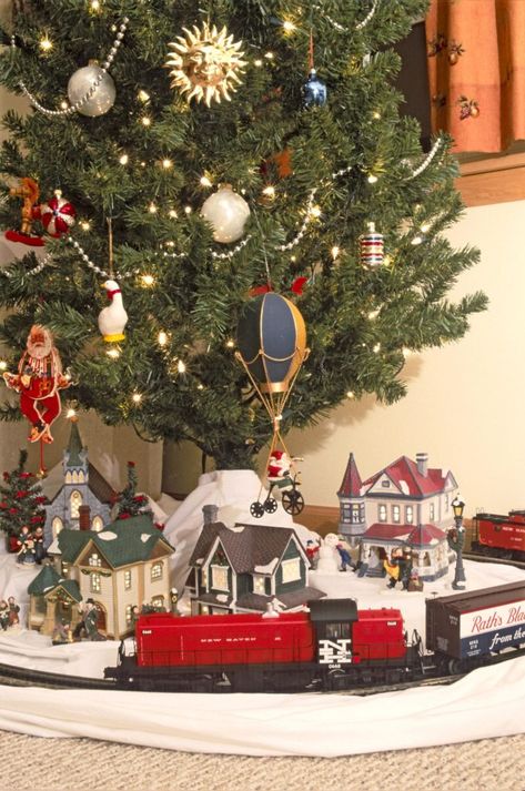 Choosing a train for the Christmas tree | News, Sports, Jobs - Lawrence Journal-World: news, information, headlines and events in Lawrence, Kansas Christmas Tree With Train And Village, Train Under Christmas Tree, Train Around Christmas Tree, Christmas Tree Train Set, Christmas Tree Train, Christmas Tree Village, Christmas Village Sets, Christmas Layouts, Christmas Tree Toy