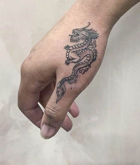 A intricate dragon tattoo by @elizabethftattoos- Creative thumb tattoos Hand Tattoos For Guys Dragon, Small Japanese Hand Tattoos, Lower Finger Tattoos, Hand Tattoos Fire, Dragon On Finger Tattoo, Women Hand Tattoos Ideas Simple, Finger To Arm Tattoos, Finger Tattoos Thumb, Dorsal Hand Tattoos