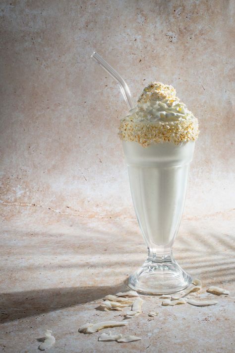 Coconut milkshake in a tall milkshake glass with a glass straw. Coconut Milkshake Recipe, Coconut Milkshake, Festive Holiday Drinks, Banana Honey, Fun Drink Recipe, Best Milkshakes, Coconut Yoghurt, Quick Dessert Recipes, Milkshake Recipe