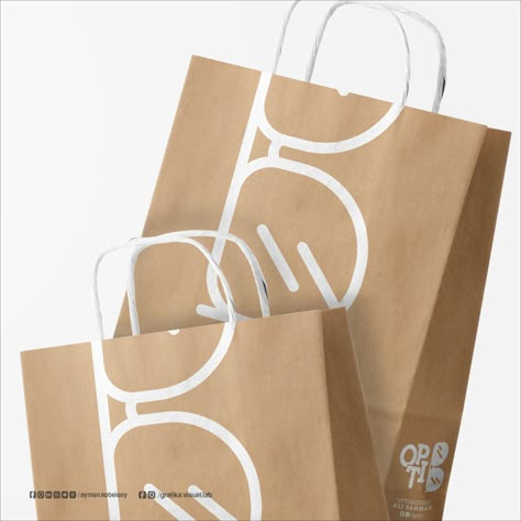 The Logo Combines the word Optic with the first letter of the owner's last name Eyewear Shop Design, Optic Logo, Optician Marketing, Eyewear Store Design, Shopping Bag Design, Paper Bag Design, Glass Store, Packaging Ideas Business, Optical Shop