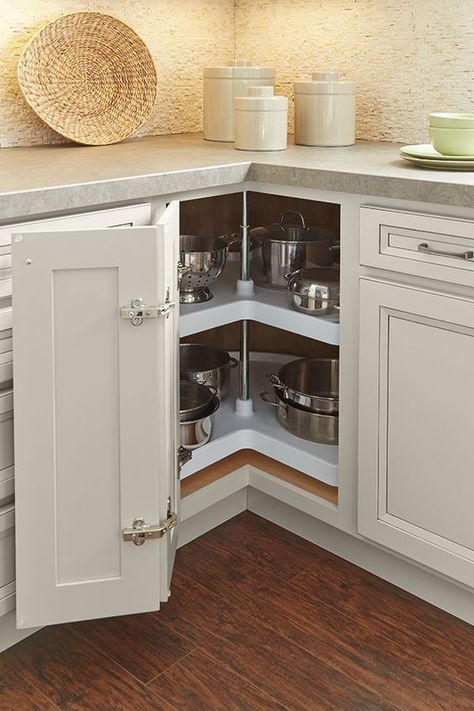 a neutral kitchen with a lazy susan cabinet that features a folding door is one of the best ideas to implement Corner In Kitchen, Lazy Susan Kitchen Cabinet, Homecrest Cabinets, Lazy Susan Corner Cabinet, Rotating Shelves, Kitchen Lazy Susan, Kitchen Cabinet Storage Solutions, Lazy Susan Cabinet, Lazy Susan Kitchen