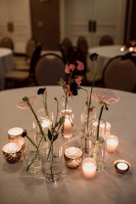 This simple and sweet table decor features pink florals and tiny candles | Image by Brandi Sisson Photography Simple Moody Centerpieces, Peony Flower Table Decoration, Peonies Table Decor, Simple Wedding Tablescapes Round, Moody Bud Vases Wedding, Simple Moody Wedding, Candles At Wedding Reception, Simple Dinner Table Decor, Florist Reference