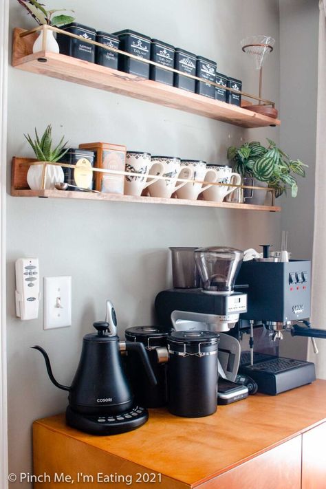 16 Coffee Bar Ideas for How to Make Your Own Coffee Station in your kitchen at Home — Learn the essentials for how to make your kitchen or dining room feel like your favorite cafe! Modern coffee bar cabinet with floating shelves, mugs, tea tins, and espresso machine Koffie Stations, Coffee Bar Decorations, Coffee Bar In Kitchen, Kaffe Station, Bar In Kitchen, Coffee Bar At Home, Coffee Bar Ideas Kitchen Counter, Bar At Home, Coffee Station Kitchen