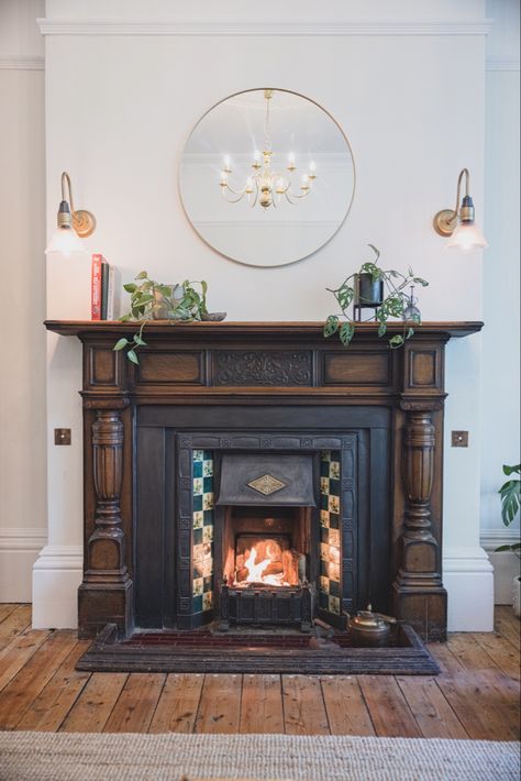 Original dark wood fire surround, period tiles, farrow and ball paint, servant bells, sanded wooden floors Fireplace Ideas Old Style, Fireplace High On Wall, 1900s Fireplace, Edwardian House Interior, Edwardian Houses, Edwardian Living Room, Edwardian Interiors, Edwardian Terrace, Victorian Fireplace Tiles