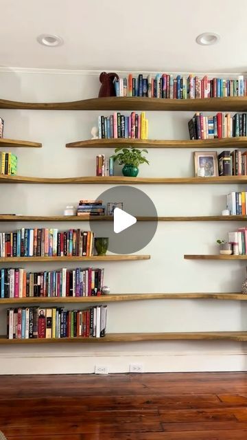 Wall Decor Daily on Instagram: "POV: You’ve been daydreaming about the perfect bookshelves, and now they’re finally a reality! 🛋️ 

These wavy wooden shelves add both character and functionality to any room. 

Imagine your favorite reads, treasured trinkets, and a few stylish plants beautifully displayed. 

❤️this like we do?

Tag someone who needs to see this. 

Thanks to @Katy for showing us how it’s done!
.
.
.
.
.

#booktok #bookshelves #floatingshelves 
#customshelving #interiorstyling" Custom Bookshelves, Apartment Deco, Open Bookshelves, Bookshelves In Living Room, Hanging Plant Wall, Custom Shelving, Bookcase Design, Bookshelf Design, Wall Bookshelves