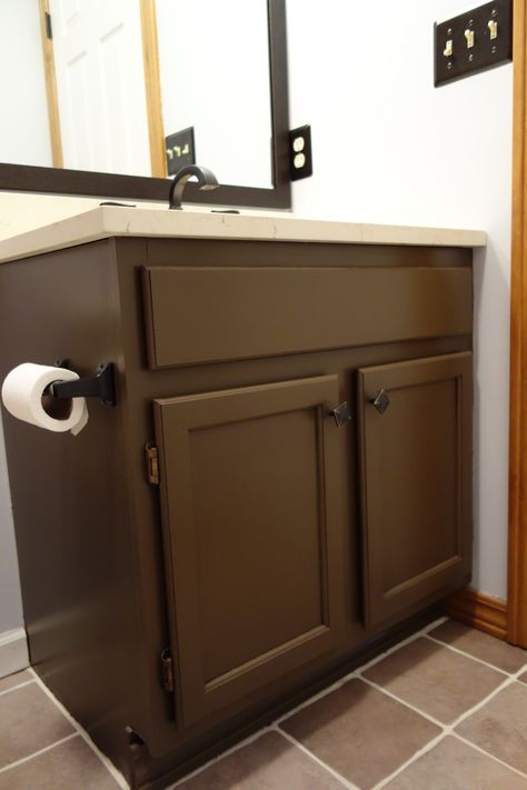 Dark Brown Vanity Bathroom Framed Mirrors, Painted Brown Bathroom Cabinets, Bathroom Dark Green Cabinets, Bathrooms With Brown Cabinets, Brown Painted Bathroom Cabinets, Brown Painted Bathroom Vanity, Brown Painted Vanity, Brown Cabinets Bathroom, Dark Brown Bathroom Vanity