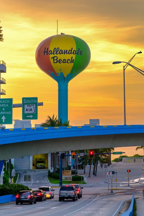 Experience the allure of Hallandale Beach, Florida, through this captivating image taken during sunrise. The Hallandale Beach Water Tower stands tall and proud as the sun’s rays paint the sky with an explosion of vibrant yellow hues. Hallandale Beach Florida, Instagram Profile Aesthetic, April Mood Board, Manifesting 2024, Tower Stand, Florida Photography, Yellow Hues, Beach Water, Water Tower