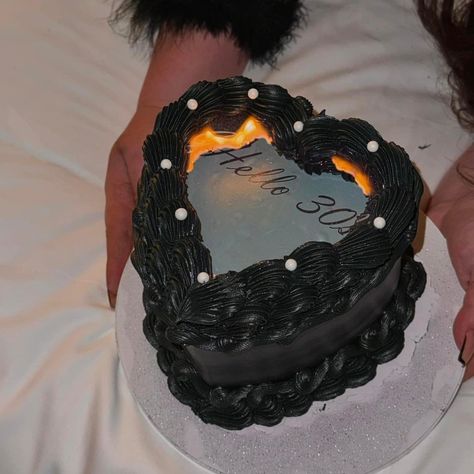 Check out this awesome "Hello 30's" cake by @sweetsbykash21 . This cake is perfect for a 30th birthday, with a dark and mysterious vibe! The cake is black with white pearl accents and has edible printed "Hello 30's" in the center with a flame design around the words. Check out our on-demand custom-printed burn away cake toppers #edibleink #cakes #customcakes #birthdaycake #30thbirthday black cakes, black birthday cake, heart birthday cake, black heart aesthetic birthday cake, 30th birthday cake Burn Cake, Black Heart Aesthetic, Black Heart Cake, Cake 30th Birthday, Birthday Cake Heart, Baseball Theme Cakes, Birthday Cake Black, Aesthetic Birthday Cake, Football Themed Cakes