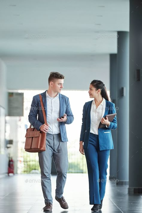 Talking entrepreneurs walking in office by DragonImages. Young smiling entrepreneurs walking along office corridor and talking about business peojects thay are working on #Sponsored #office, #DragonImages, #Young, #Talking Walking And Talking Pose, Office Photoshoot Ideas Work Spaces, Fashion Pose Reference, 2 People Talking, 2 Person Office, China Illustration, Office Shoot, Office Corridor, Photography Office