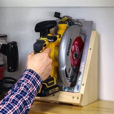 Learn how to make a DIY circular saw storage holder with these step-by-step plans. This space-saving DIY holder is the perfect way to store a circular saw in your workshop. This is a simple afternoon project that can be made with a few simple cuts, a few common tools, and a few pieces of scrap wood. Get the easy-to-follow plan now! Circular Saw Storage, Saw Storage, Working Tables, Cleat Storage, Door Remodel, Shop Hacks, Woodshop Ideas, Garage Organizing, Lazy Man