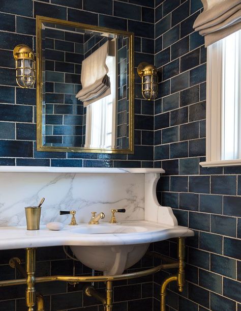 Although the washstand from New York’s Urban Archeology is new, Young gave this client’s bathroom a heritage feel with a brass faucet, nautical sconces and navy tile. | Photographer: John Bessler | Designer: Young Huh Navy Bathroom, Blue Bathroom Tile, Captains Quarters, Stick Tiles, Victorian Bathroom, Bad Inspiration, Spanish Revival, Downstairs Bathroom, Blue Bathroom