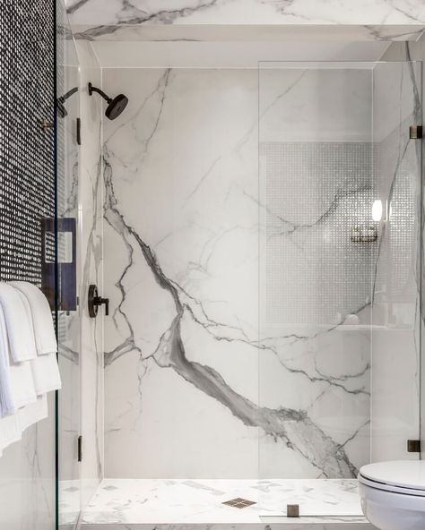 A Carrara-look slab shower for the ultimate in a natural stone look without the maintenance. #porcelain #porcelainslab #tile #luxurydesign… Bathroom Interior Design Modern Master Bath, Slab Shower Walls, Guests Bathroom, White Marble Shower, Tile Selection, Modern Master Bath, Bathroom Interior Design Modern, White Marble Bathrooms, Bathroom Shower Walls