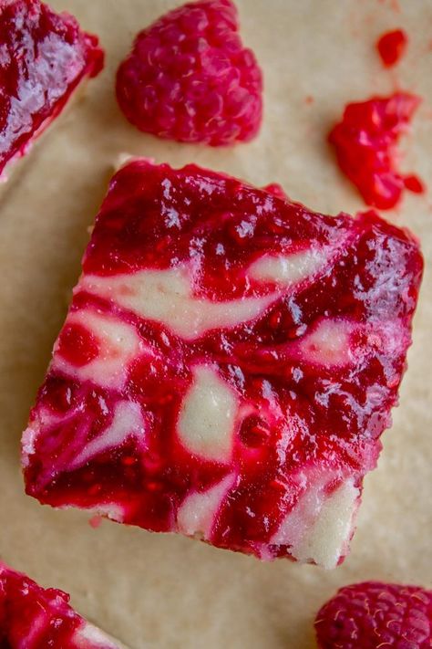 Raspberry Cheesecake Bars - The Food Charlatan Raspberry Cheesecake Bars, Raspberry Swirl Cheesecake, Cream Cheese Bars, The Food Charlatan, Swirl Cheesecake, Food Charlatan, Raspberry Recipes, Shortbread Crust, Fresh Raspberries