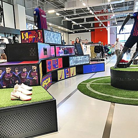 Image showing the interior of Nike's Barcelona flagship store. Roller Boogie, Retail Display Shelves, Nike Retail, Raleigh Bikes, Qatar Football, Illuminated Signage, Retail Trends, Reading Projects, Retail Shelving