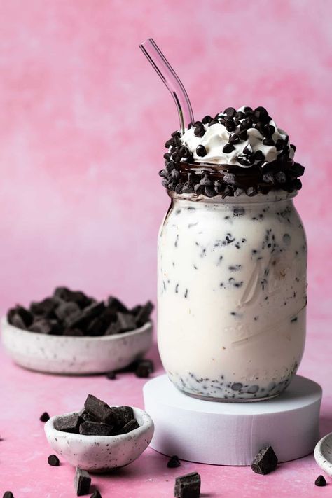 A chocolate chip milkshake is on a white puck and a pink background with chocolate chips in small plates around the milkshake. Chocolate Chip Milkshake, Ice Cream Milkshake, Mint Chocolate Chip Milkshake, Vanilla Milkshake, White Hot Chocolate, Chocolate Chip Ice Cream, Choco Chips, Milkshake Recipes, Ice Cream Popsicles