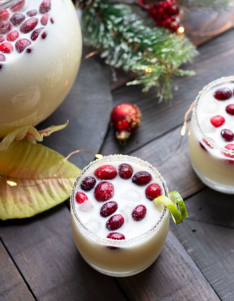 This Holiday Coconut Margarita Pitcher is perfect for entertaining guests throughout the winter. Fresh cranberries and a sugared rim complete this margarita with tequila, white cranberry juice, Malibu, fresh lime juice, orange juice and coconut milk. This Holiday Coconut Margarita Pitcher is perfect for entertaining guests throughout the winter. Fresh cranberries and a sugared rim Cranberry Coconut Margarita, Coconut Margarita Pitcher, Coconut Cranberry Margarita, Holiday Margaritas Pitcher, Winter Margarita Recipe, Pitcher Cocktails Winter, Christmas Coconut Margarita, Holiday Pitcher Cocktails, Christmas Pitcher Cocktails