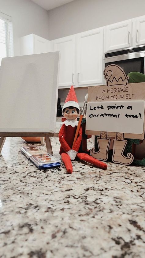 This Elf on the Shelf setup is such a cute and creative idea for a holiday activity! The elf is holding a brush with a message that says, "Let's paint a Christmas tree!" along with an easel, canvas, and paint palette. And the best part? You can find all these items at Dollar Tree, making it budget-friendly! This setup would definitely make a memorable morning surprise for little ones, sparking their creativity for the holiday season. Paint A Christmas Tree, Creative Idea, Paint Palette, Holiday Activities, On The Shelf, The Elf, Dollar Tree, Elf On The Shelf, Budget Friendly