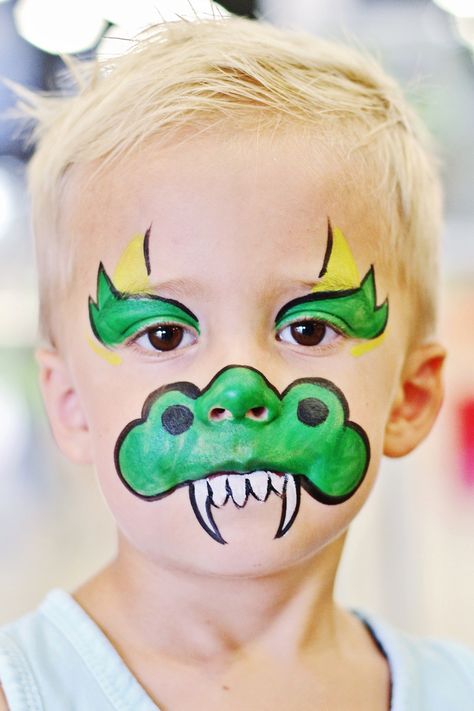 Cute green dragon face painting- Fancy Faces OKC Monster Crown, Dragon Face Paint, Kids Face Painting Easy, Horned Monster, Dinosaur Face Painting, Dragon Face Painting, Carnaval Make-up, Easy Face Painting Designs, Face Painting For Boys