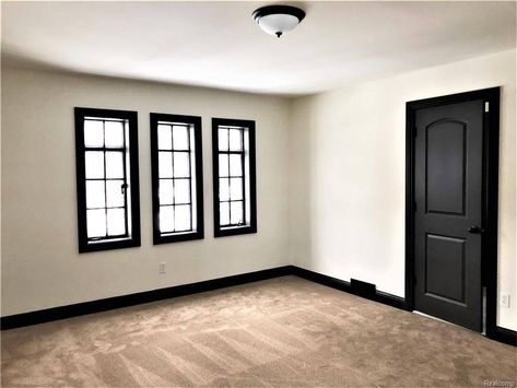 Charcoal Baseboards, Black Trimming Interior, Dark Painted Doors And Trim, Base Trim Color Ideas, Dark Painted Baseboards And Trim, Dark Door Interior, Matte Black Baseboards, Black Baseboards And Doors, Black Stained Trim Interior