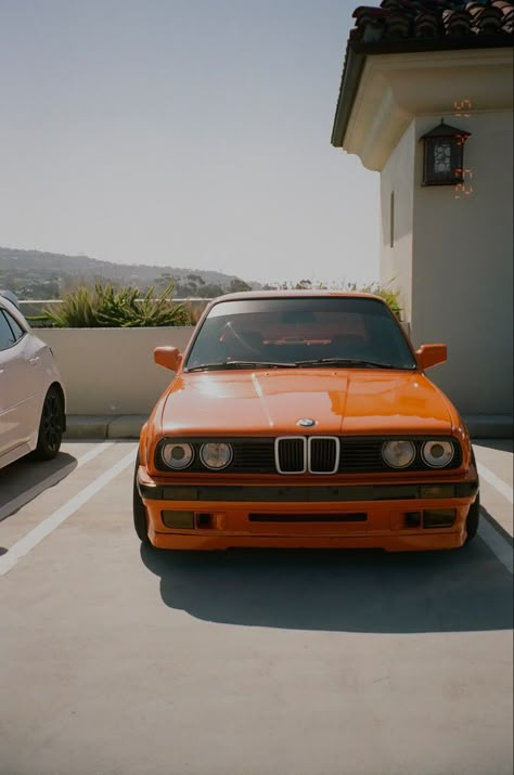 an orange bmw e30 shot on film Dream Car Bmw, Aesthetic Bmw, Bmw Aesthetic, Frank Ocean Aesthetic, Ocean Room Decor, Frank Ocean Wallpaper, Frank Ocean Poster, Bmw M3 E30, Aesthetic Dream