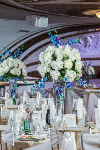 Blue orchid centerpieces Blue Orchid Centerpieces, Teal Wedding Flowers, Branch Arch Wedding, Blue Orchid Wedding, Inexpensive Wedding Flowers, Wedding Flowers Tulips, Diy Wedding Arch, Wedding Flowers Sunflowers, Bright Wedding Flowers