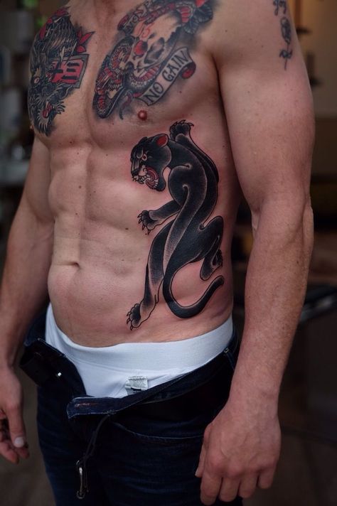 "Incredible Chest Tattoos for Men: 10 Unique and Eye-Catching Designs" Black Panther Chest Tattoo Men, Panther Tattoo Ribs, Back Panther Tattoo, Panther Chest Tattoo Men, Panther Rib Tattoo, Neotraditional Rib Tattoo, Panther Tattoo Chest, Panther Stomach Tattoo, Black Panther Tattoo Men