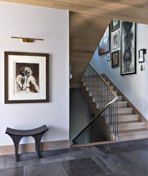 In the entry hall, a Visual Comfort & Co. picture light illuminates a vintage painting found at Susan Wheeler Home and a Global Views stool. The gallery wall includes works by Kader Boly and Gloria Vanderbilt. Basement Media Room, Susan Wheeler, White Oak Kitchen, Mercer Island, Architecture Home, Luxurious Home, Kitchen Views, Global Views, Luxe Interiors