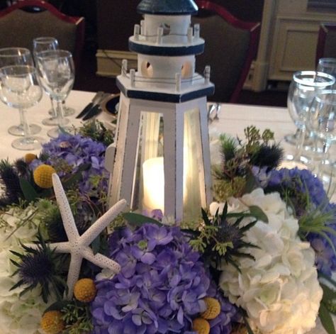 Lighthouse Floral Arrangements, Lighthouse Centerpiece Wedding, Lighthouse Centerpiece Ideas, Lighthouse Centerpieces, Navy Tablescape, Nautical Centerpieces, Boat Centerpieces, Lighthouse Theme, Rehearsal Dinner Centerpieces