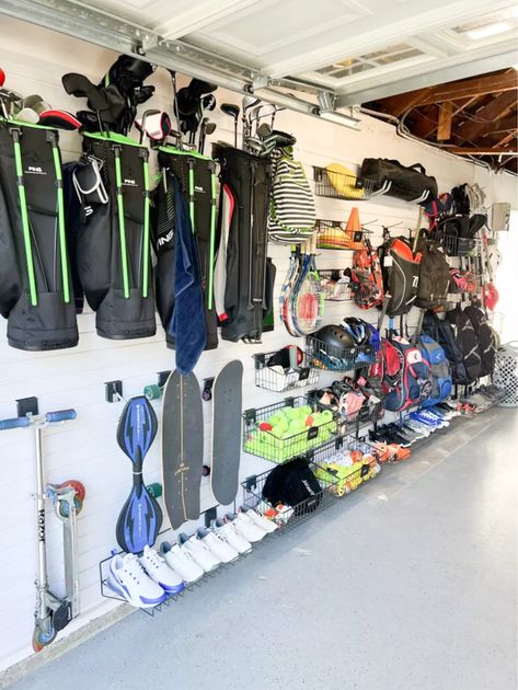 As a professional organizer, finding systems to organize garages is my absolute favorite! Tap to shop my garage organization must-haves Garage Organization Ideas Sports Equipment, Garden Garage Storage, Baseball Bag Storage Garage, Garage Baseball Organization, Hang Stroller In Garage, Baseball Organization Ideas Garage, Sport Storage Garage, Gear Garage Organization, Scooter Organization In Garage