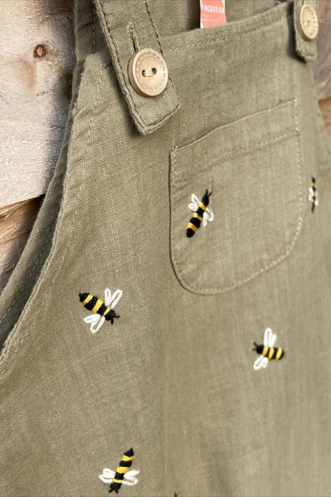 Who agrees that the only thing cuter than little linen dungarees are little linen dungarees with hand embroidered bees? 🐝 They also happen to be a clue for something exciting coming soon… keep an eye out! Shop hand embroidered, sustainable, upcycled adult and children's clothing as well as embroidery hoop decor and PDF patterns on Etsy: https://www.etsy.com/uk/shop/Pincushionembroidery Linen Dungarees, Hoop Decor, Embroidery Hoop Decor, Minimal Shirt Design, Baby Overall, Bee Embroidery, Baby Sewing Projects, Pola Sulam, Embroidery On Clothes