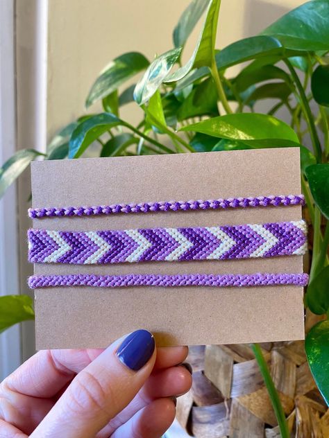 Affordable and Simple Friendship Bracelet Patterns to Try Now Purple Chevron Bracelet, Purple Bracelet Patterns, Friendship Bracelet Sets, Friendship Bracelet Set, Small Friendship Bracelets, Friendship Bracelets Colors, Purple Friendship Bracelet, Simple Friendship Bracelet Patterns, Chevron Bracelets