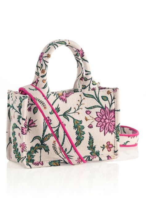 Carry your summer essentials in style with Shiraleah's Lana Mini Tote. This soft but structured canvas bag features a stylish pink and green jacquard floral design. With double handles and a matching detachable cross-body strap, there are endless ways to wear this purse. Pair with other Shiraleah items to complete your look! Features double handles, a detachable cross-body strap, magnetic snap closure, and 1 inner zip pocket Shiraleah is a trend-driven lifestyle brand focused on the little gifts Green Floral Design, Potli Bags, Handmade Jewelry Earrings, Pink Floral Pattern, Jute Bags, Leather Bags Handmade, Tote Bag Leather, Mini Tote, Beaded Bags