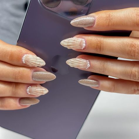 The best beach nails🤭 sea shell and sand nails😍😍 perfect summer nails for my neutral girlies 🤍🤎🤍 Gel x full: $50 Intricate nails x6: $30 Simple nails x4: $5 Total: $85 #summernails #nailideas #nailinspo #seashellnails #3dnails #cateyenails #velvetnails #nashvillenails #clarksvillenails #clarksvillenailtech #nailsofinstagram Nails Shell Design, Shell Nail Design, Nails With Shells, Summer Nails Shell, Beach Nails Shell, White Shell Nails, Shell Nails Designs, Neutral Beach Nails, Beach Nail