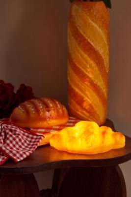 Add a tasty treat to your space with this croissant light. The portable light is battery-powered for use in whichever space you need, complete with a pastry design. **Content + Care** \- Plastic \- Wipe clean \- Requires 3 x AAA batteries (not included) | Urban Outfitters Croissant Lamp - Orange Pastry Design, Orange Fits, Cool Lamps, Portable Light, Loaf Bread, Croissant, Latest Styles, Yummy Treats, Cleaning Wipes