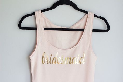 DIY Bridesmaid Tank Tops Blush and Gold || Nikki's Plate Diy Bridesmaid Proposal, Gold Shirts, Bridesmaid Proposal Diy, Cricut Iron On Vinyl, Bridesmaid Tank Tops, Bridesmaid Diy, Bridesmaid Shirts, Best Free Fonts, Bridesmaid Proposal Box