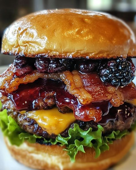 The Bacon Blackberry Cheesecake Burger 🍔 Ingredients: - 1 lb ground beef - 4 slices bacon, cooked - 4 hamburger buns - 1/2 cup blackberry preserves - 4 slices cream cheese or 1/2 cup whipped cream cheese - 1/4 cup fresh blackberries (optional) - 1/2 teaspoon freshly cracked black pepper - 1/2 teaspoon garlic powder - Salt to taste - 1/4 cup arugula or spinach leaves - Olive oil for cooking Instructions: 1. In a bowl, mix the ground beef with cracked black pepper, garlic powder,... Blackberry Preserves, Olive Oil For Cooking, Burger Ingredients, Blackberry Cheesecake, Meat Diet, Gourmet Burgers, Whipped Cream Cheese, Healthy Food Dishes, Hamburger Buns