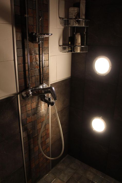 There’s no worse feeling than taking a shower in a bathroom that’s dim and poorly lit. Luckily, there are a lot of easy shower lighting options that y... | Include Side Lighting for Darker Areas #showerlights #showerlighting #bathroomlight #bathroomlighting #shower #decoratedlife Hgtv Bathrooms, Shower Lighting Ideas, Glass Shower Wall, Dark Accent Walls, Moderne Pools, Small Bathroom Sinks, Modern Lake House, Washroom Decor, Powder Room Makeover