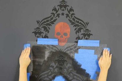 Hey there! Ever craved a bold accent wall but didn’t know where to start? Well, we have a unique but fun DIY stencil project that’s sure to satisfy. Let’s get stenciling! The stencils used for this spooky DIY project are the Abundance Damask Stencil and the Skull Stencil #3. The paints used for the basecoat and Damask stencil are Benjamin Moore Ashland Slate and Black. The paints used for the skulls are Modern Masters Plum and Copper. We suggest using a 4” stencil roller for the dam… Bold Accent Wall, Casa Rock, Trending Wall Art, Diy Halloween Home Decor, Damask Wall Stencils, Damask Wall, Best Wall Art, Skull Stencil, Diy Stencil